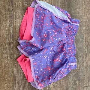 Pink and purple champion athletic shorts with booty shorts underneath attached